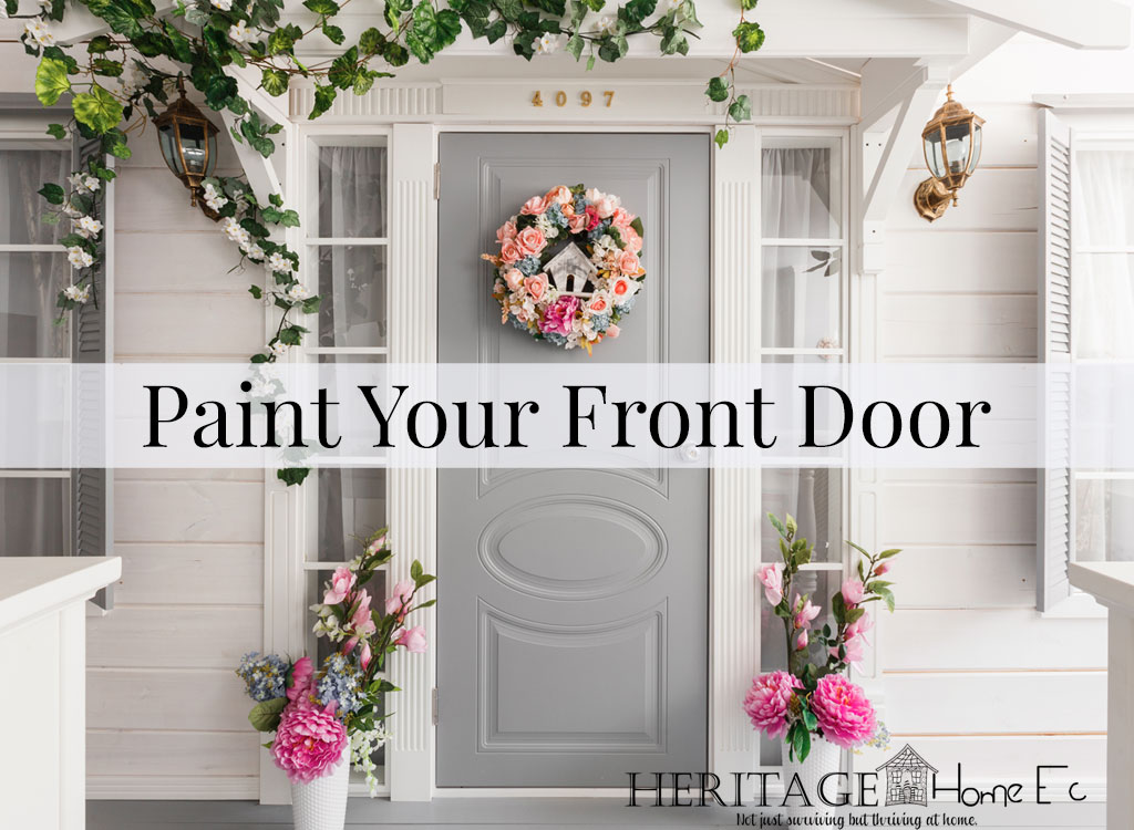 White small wooden house with gray door. spring flower decoration