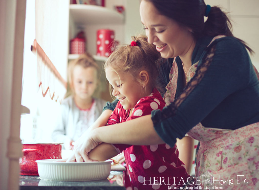 a woman cooking in the kitchen with her children