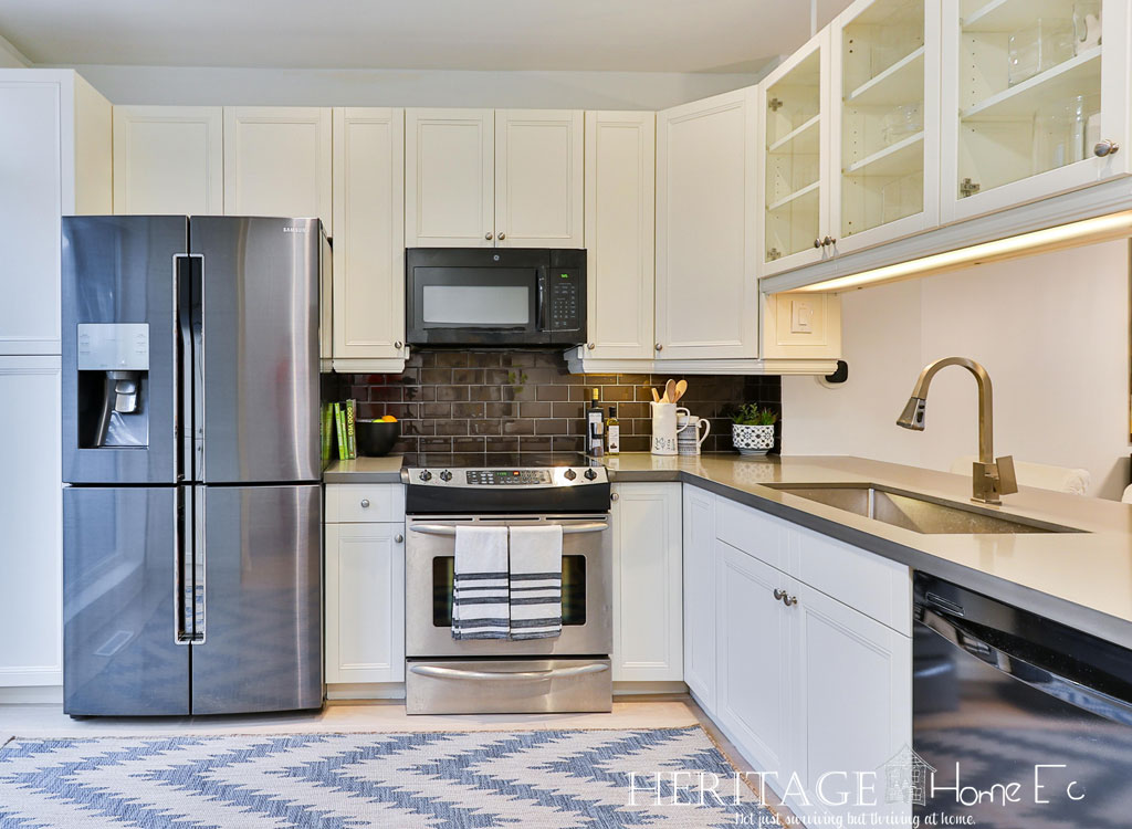 modern stainless steel appliances in white kitchen