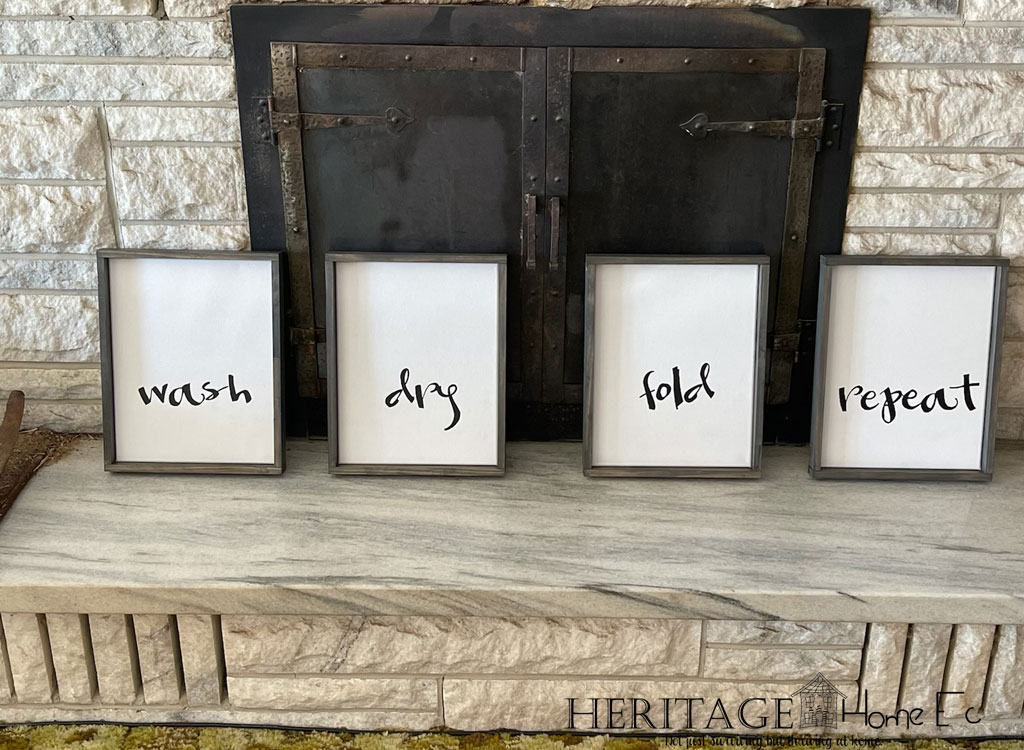 laundry signs framed sitting on fireplace hearth