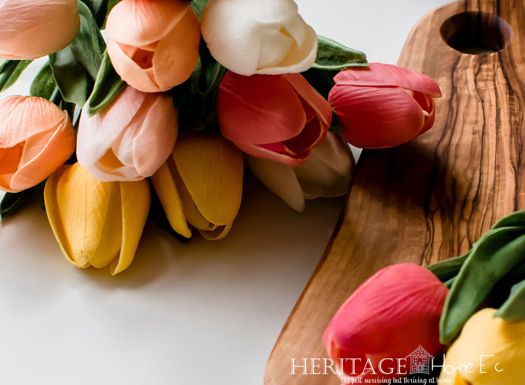 bouquet of tulips with wood cutting board on white background