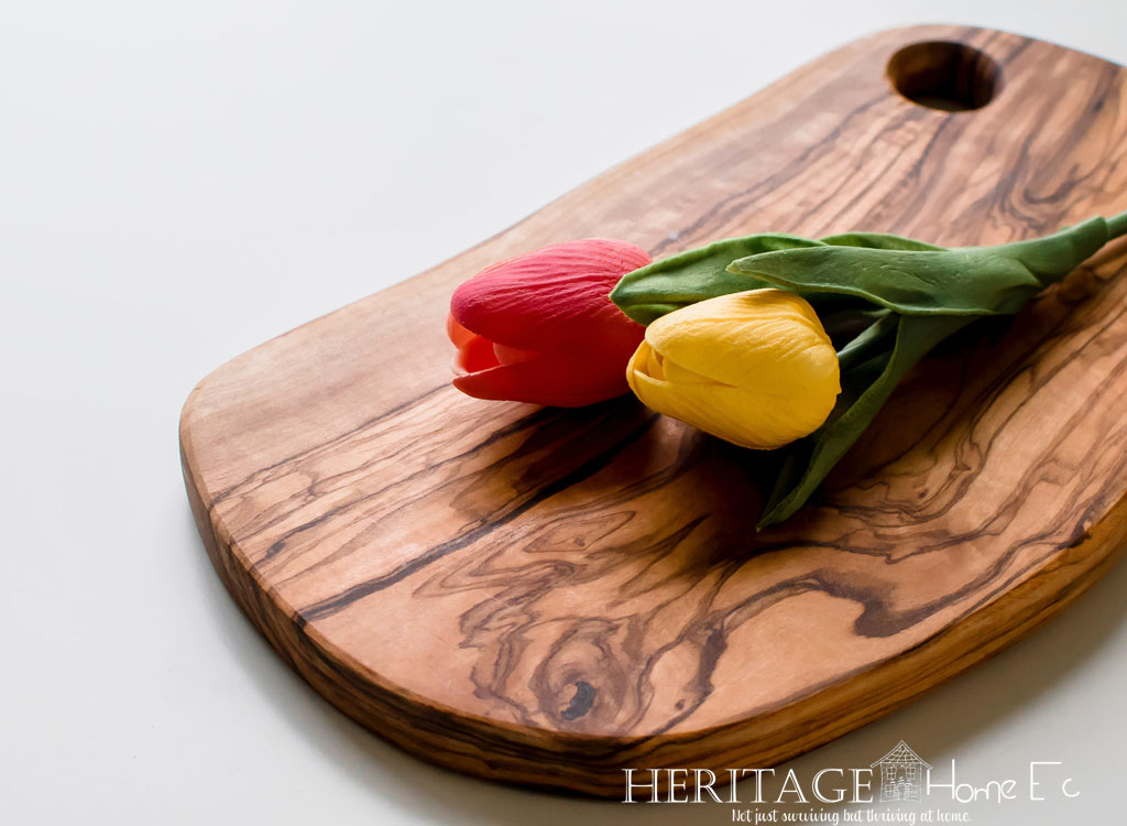 red and yellow tulips on oval wooden cutting board