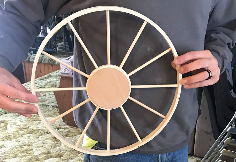farmhouse wagon wheel wreath complete and plugged to decorate