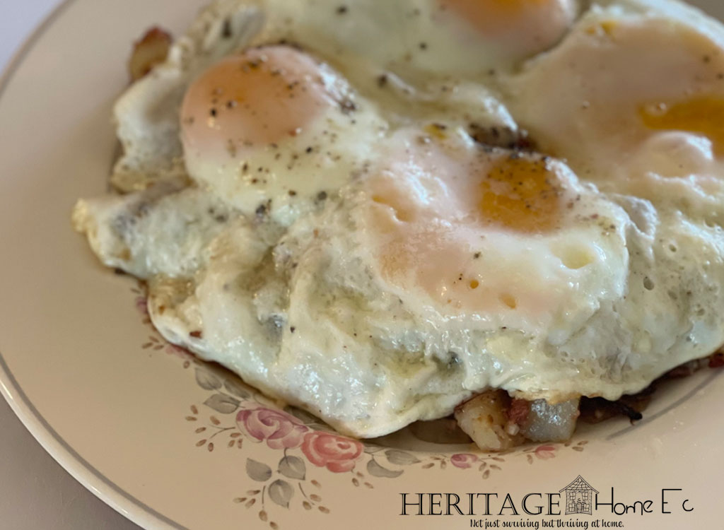 corned beef hash on plate with fried eggs on top