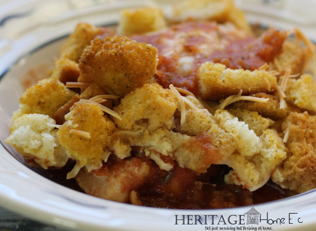 close up of chicken parmesan with croutons and cheese