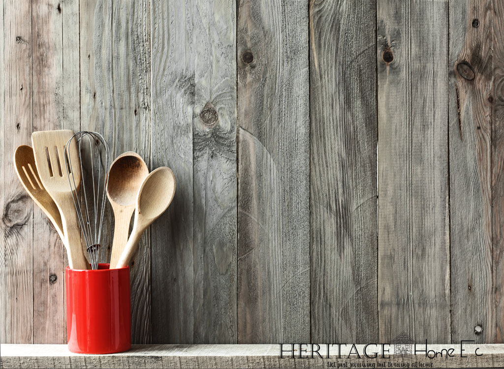 red can with wooden utensils and whisk against wooden backdrop