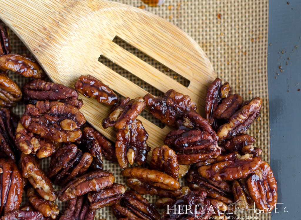 pecans on mat with wooden spoon