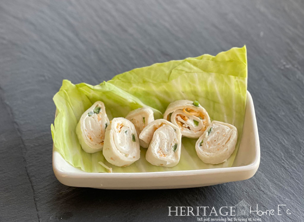 rolled up pinwheels in dish with fresh lettuce leaf garnish